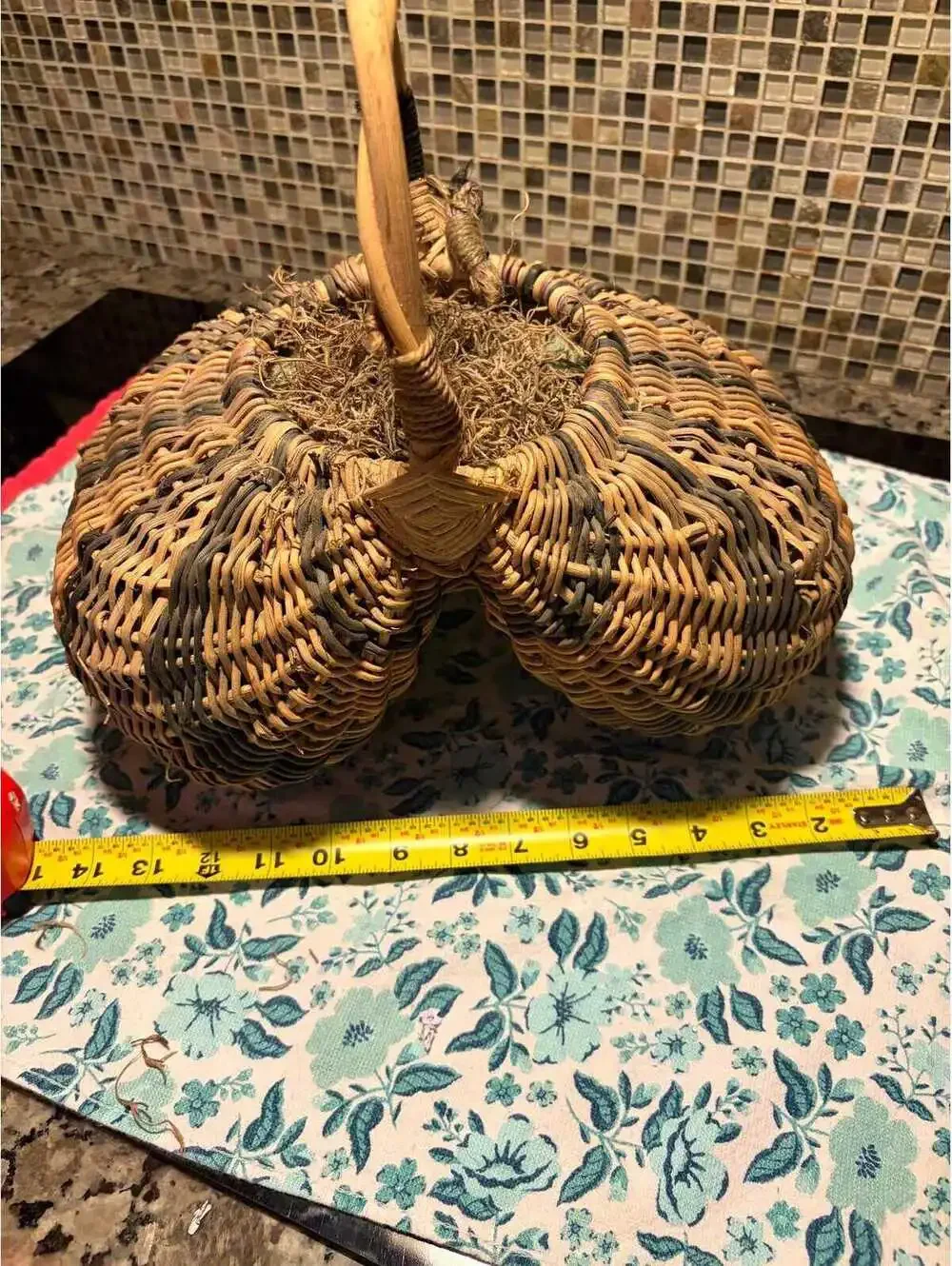 This is a vintage hand-woven double buttocks wicker harvest basket.